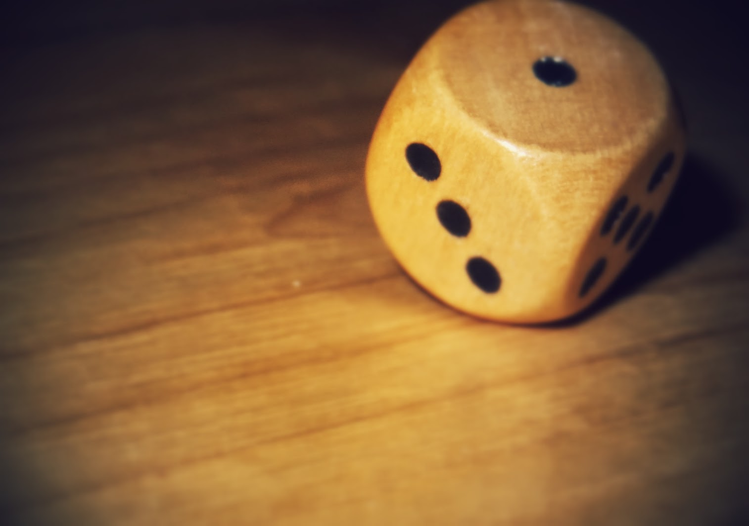 a wood dice on the ground is looking like he has fallen