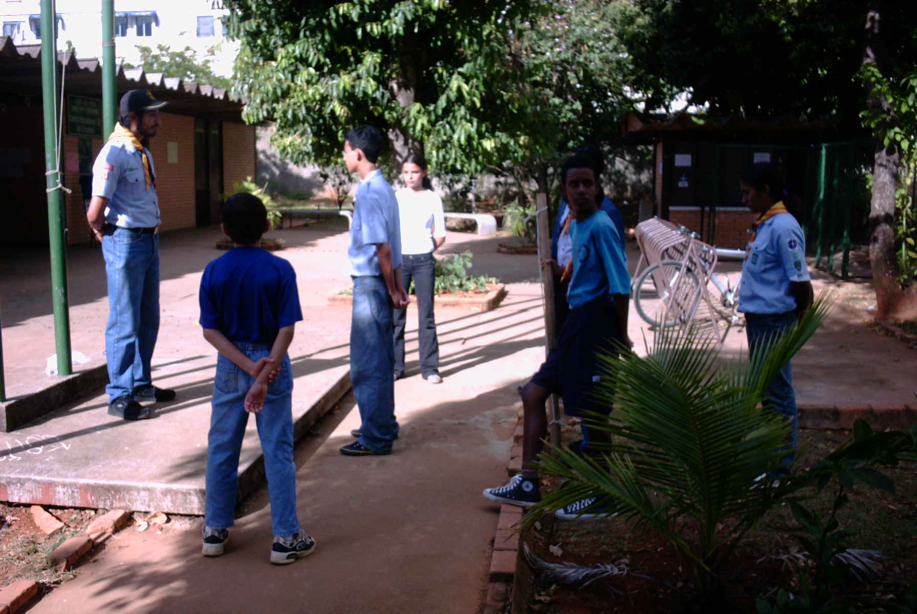 the group of people are standing around talking