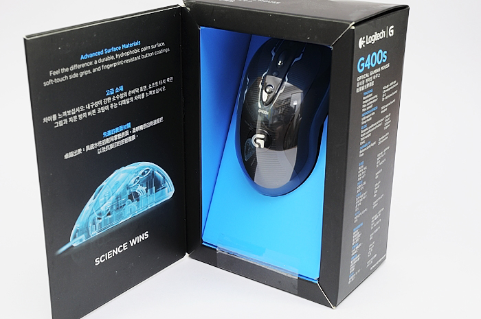 an opened box containing a computer mouse and a blue object