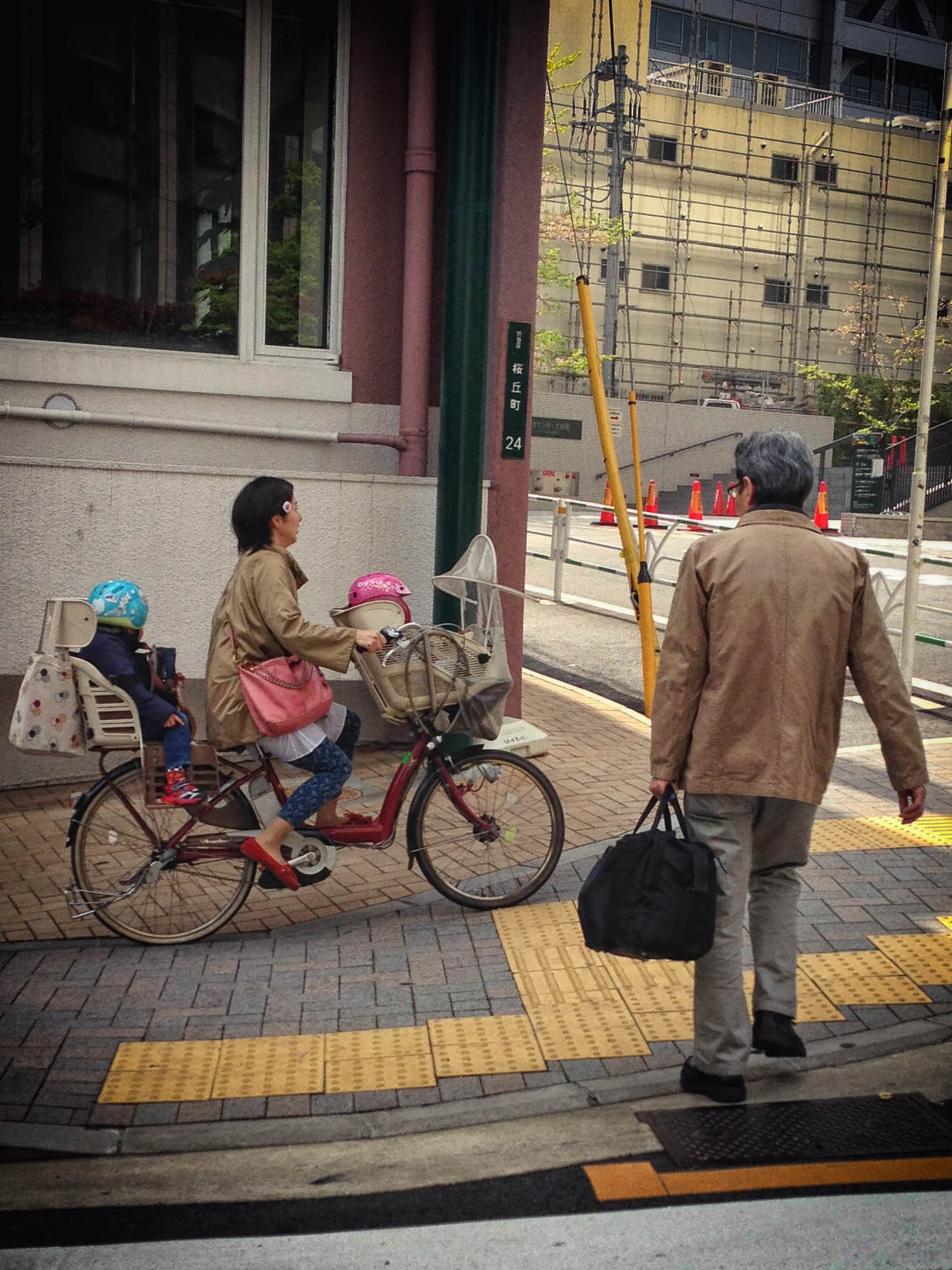 a person riding a bike, with a child and a bicyclist