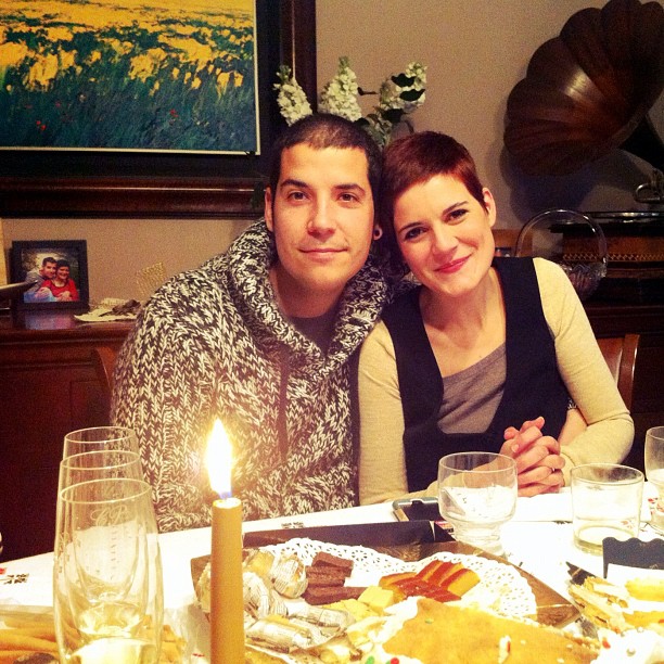 the couple has their arms around each other at a table in front of candles