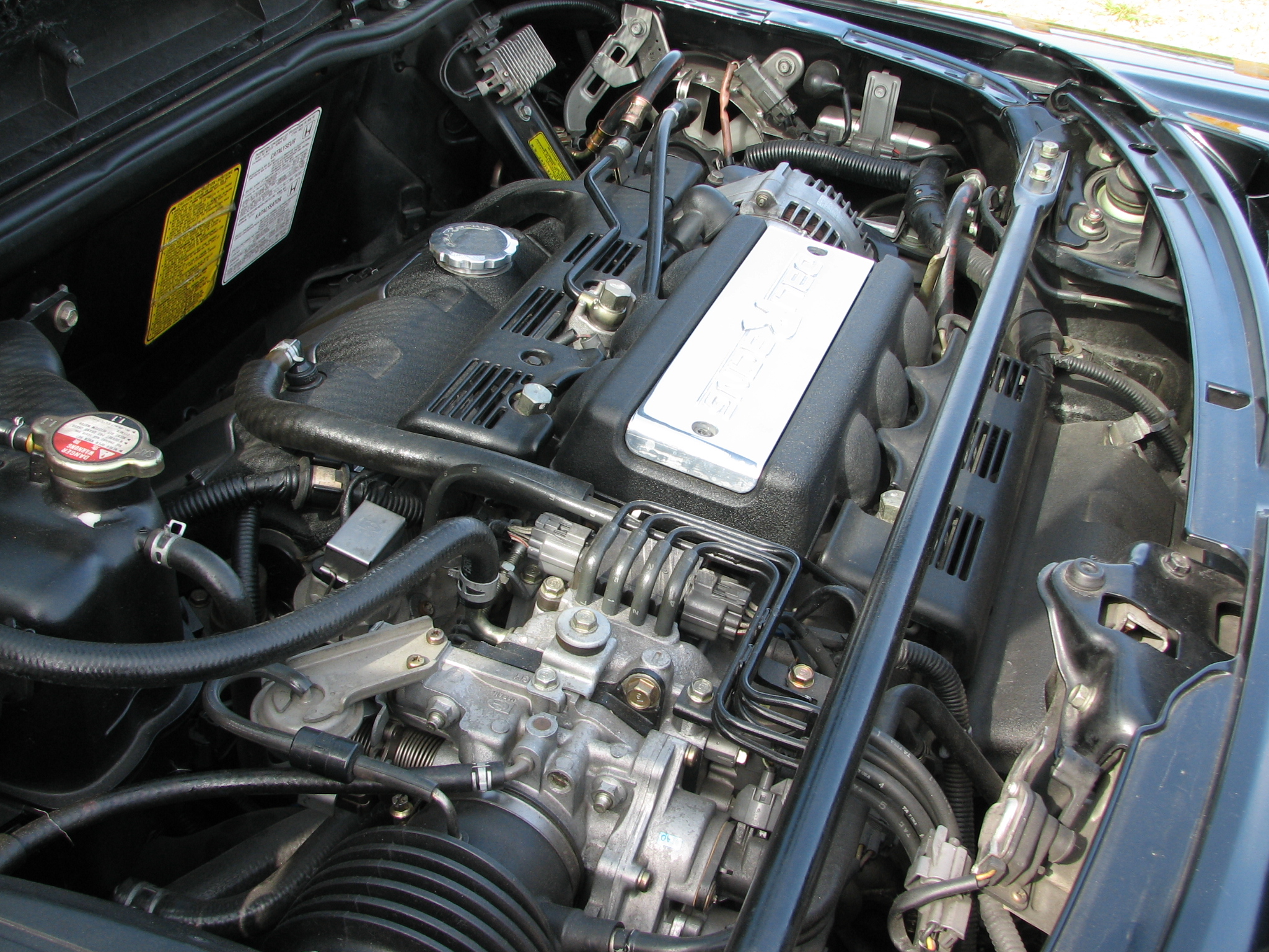 an engine compartment with some wires attached to the engine