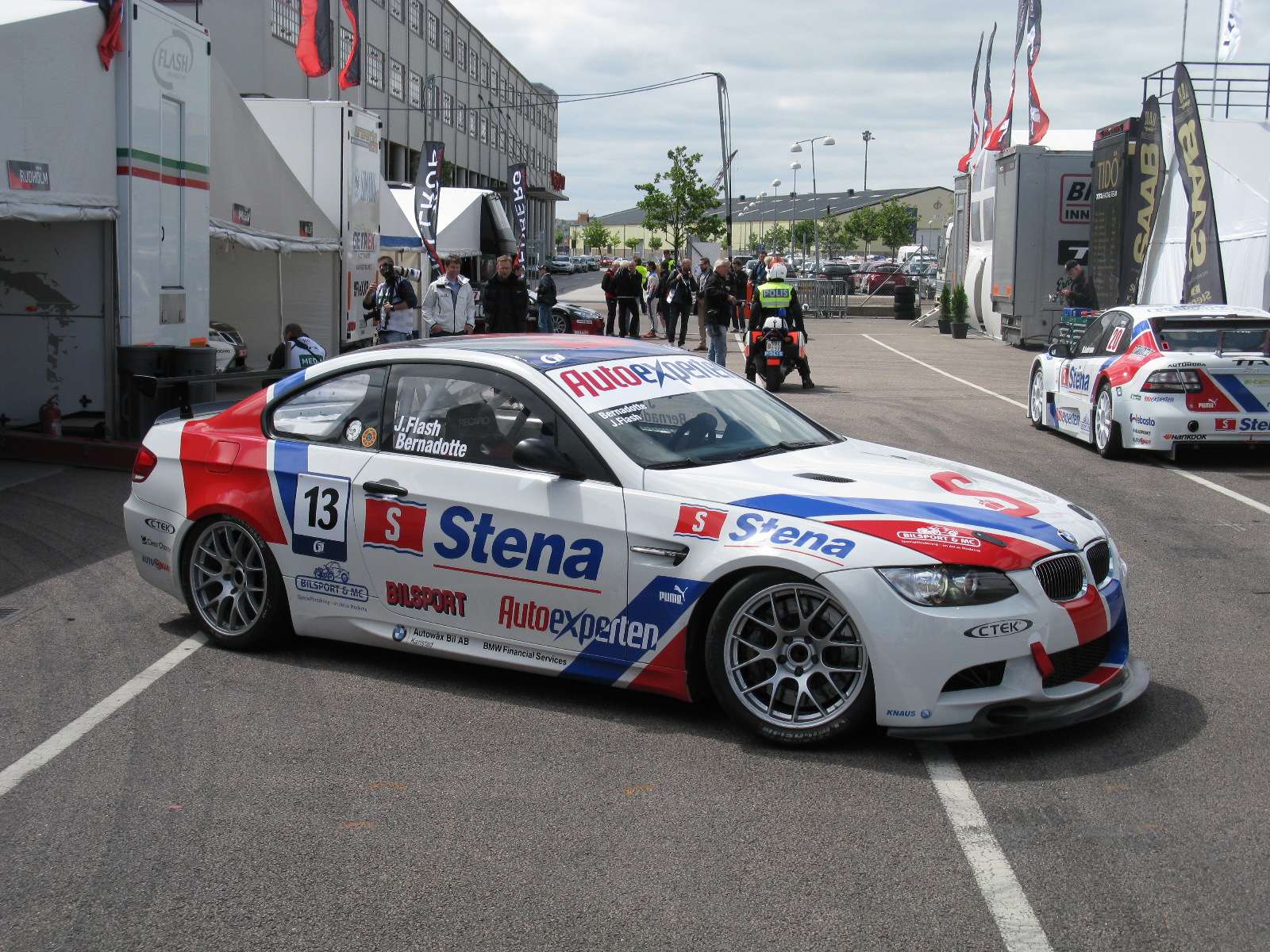 two bmw race cars sitting side by side