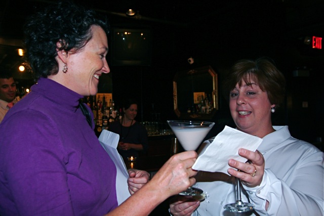 two women at the bar enjoying cocktails with drinks