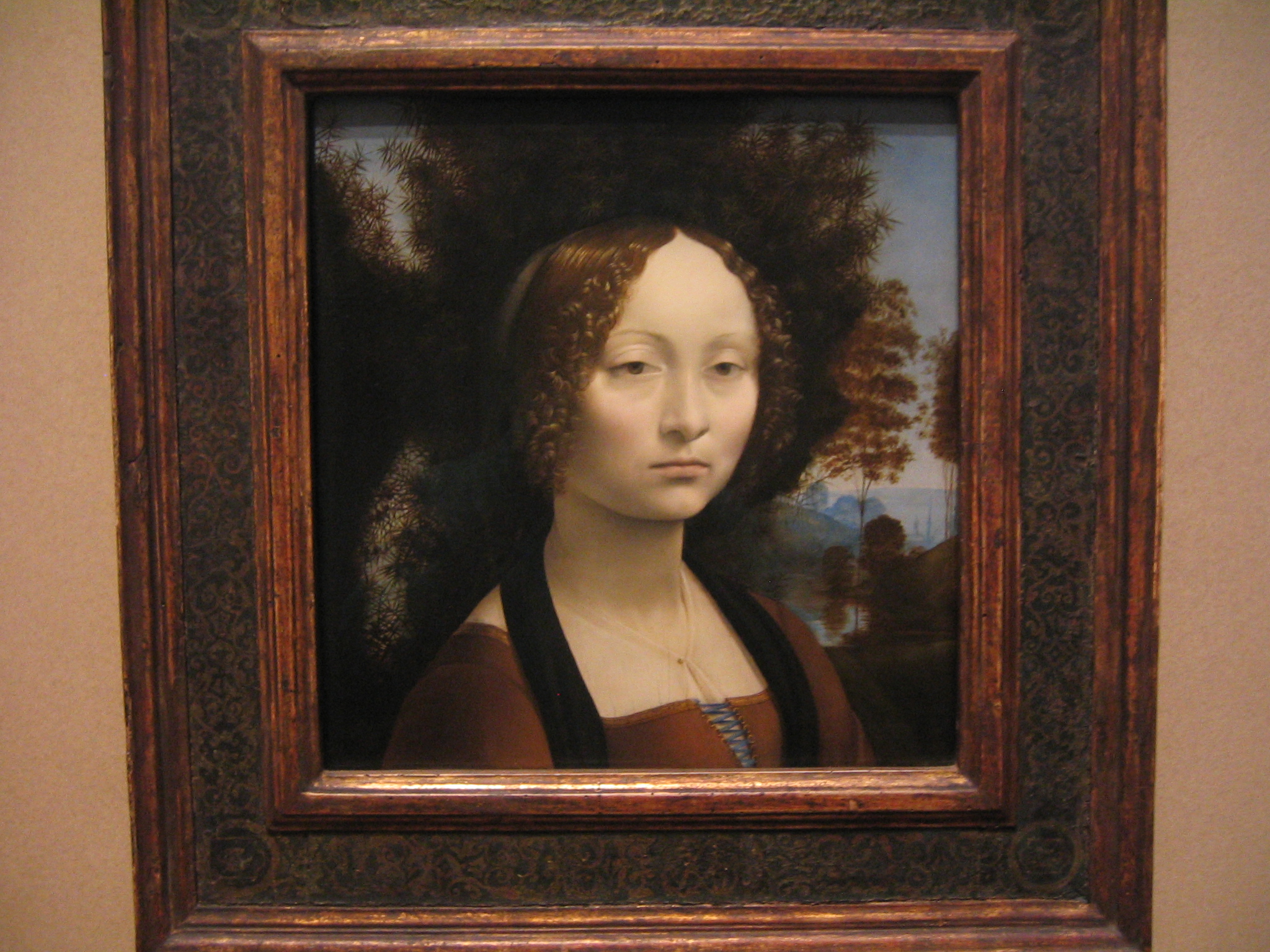 a painting of a girl with an elaborate frame on display