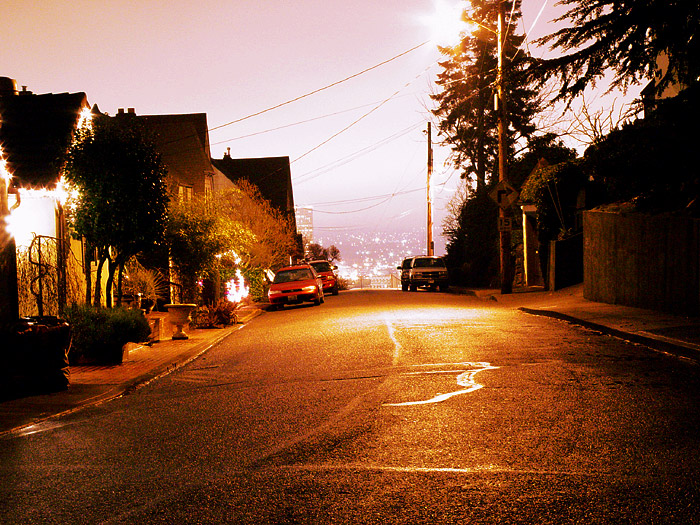 street with no cars at night, only one car and three