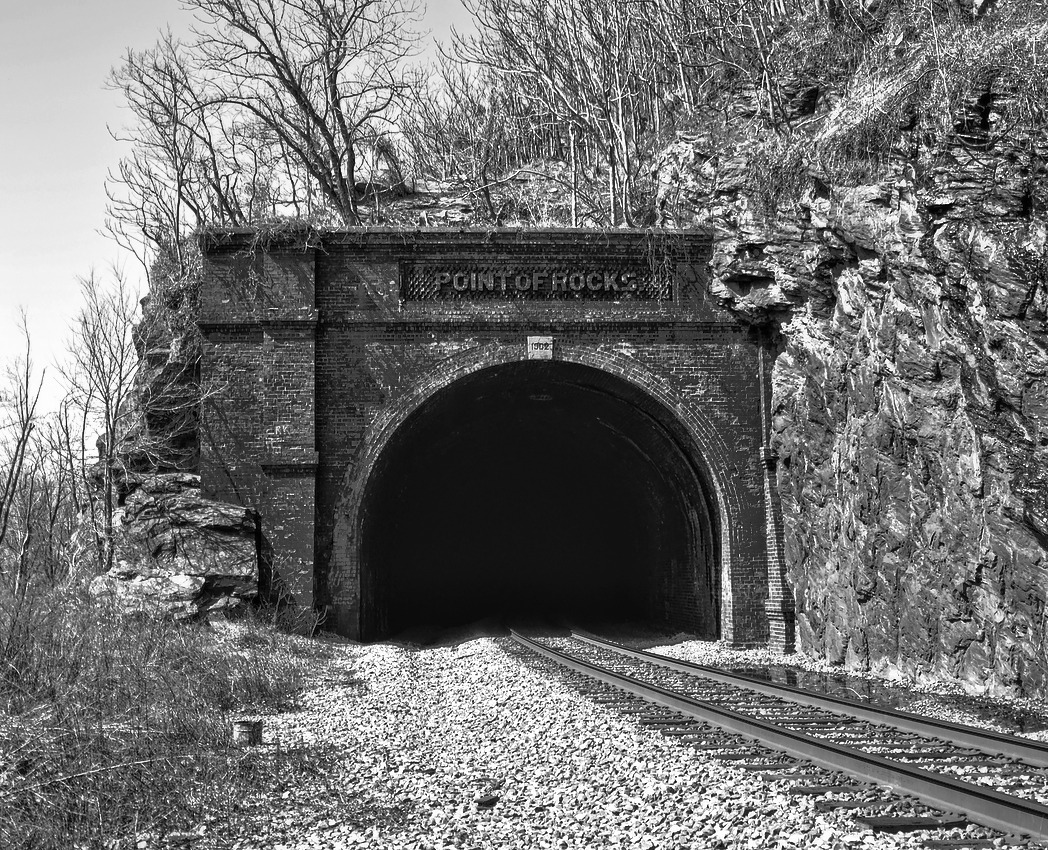 a train track passes through a tunnel