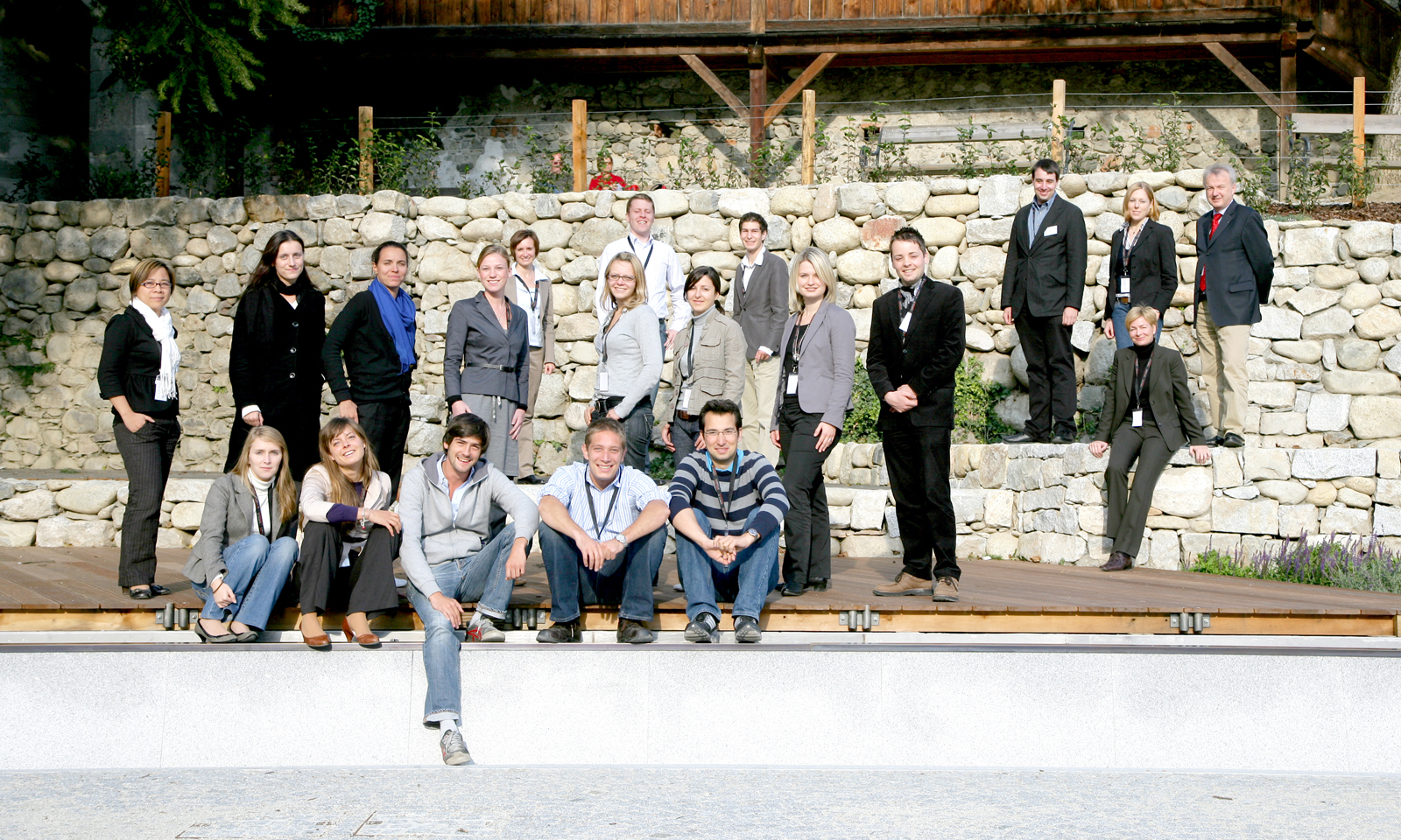 group of people on a large wall posing for a po