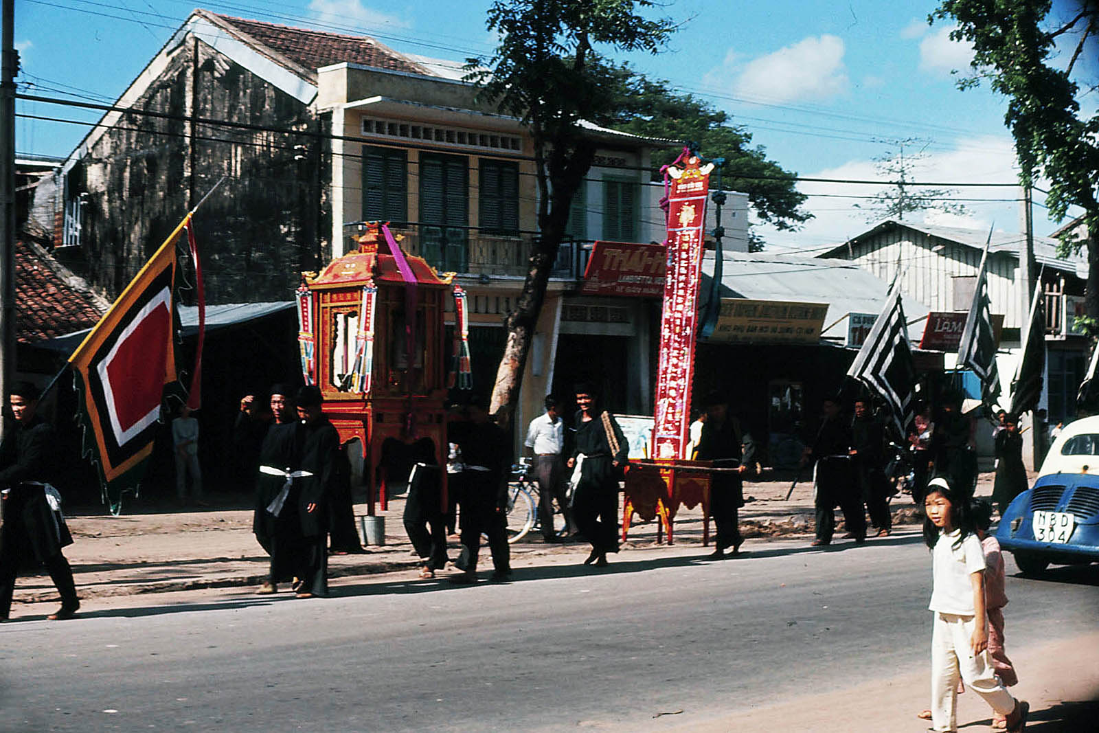 people walking down a street, some holding signs and other carrying flags