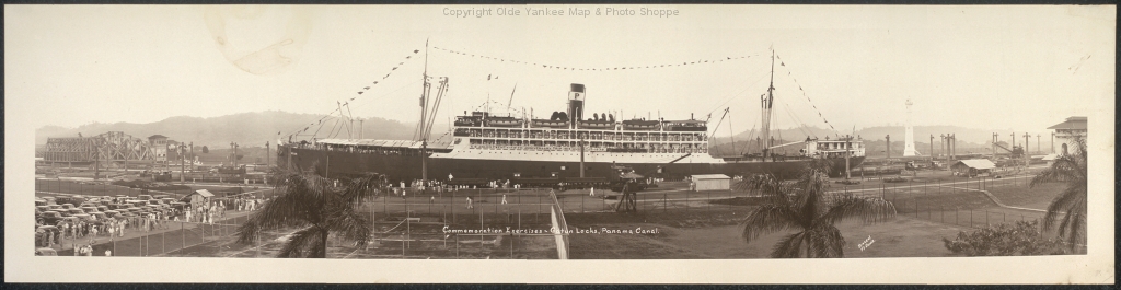 large boat in dock at small city area