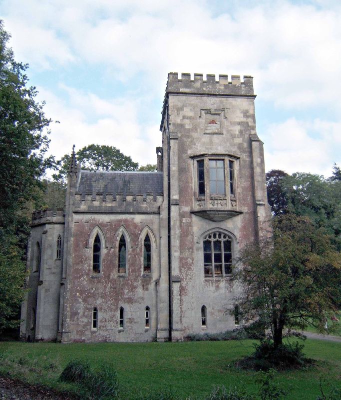 a stone castle with lots of windows and lots of grass