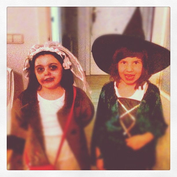 two girls in costume posing for a picture