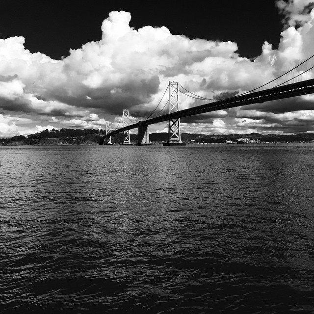 a black and white po of the bridge over the water