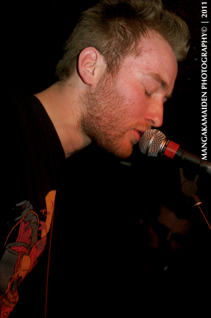 a man is singing into a microphone with his mouth