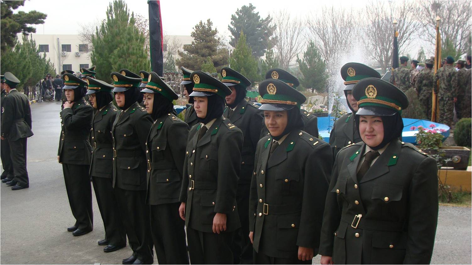 a group of women in military dress clothes stand near each other