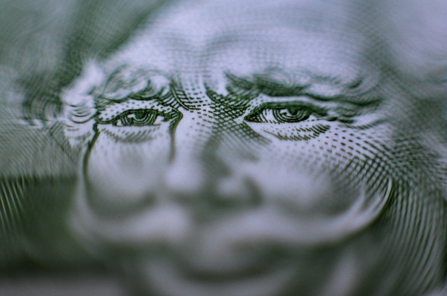 closeup of an embossed portrait on top of money