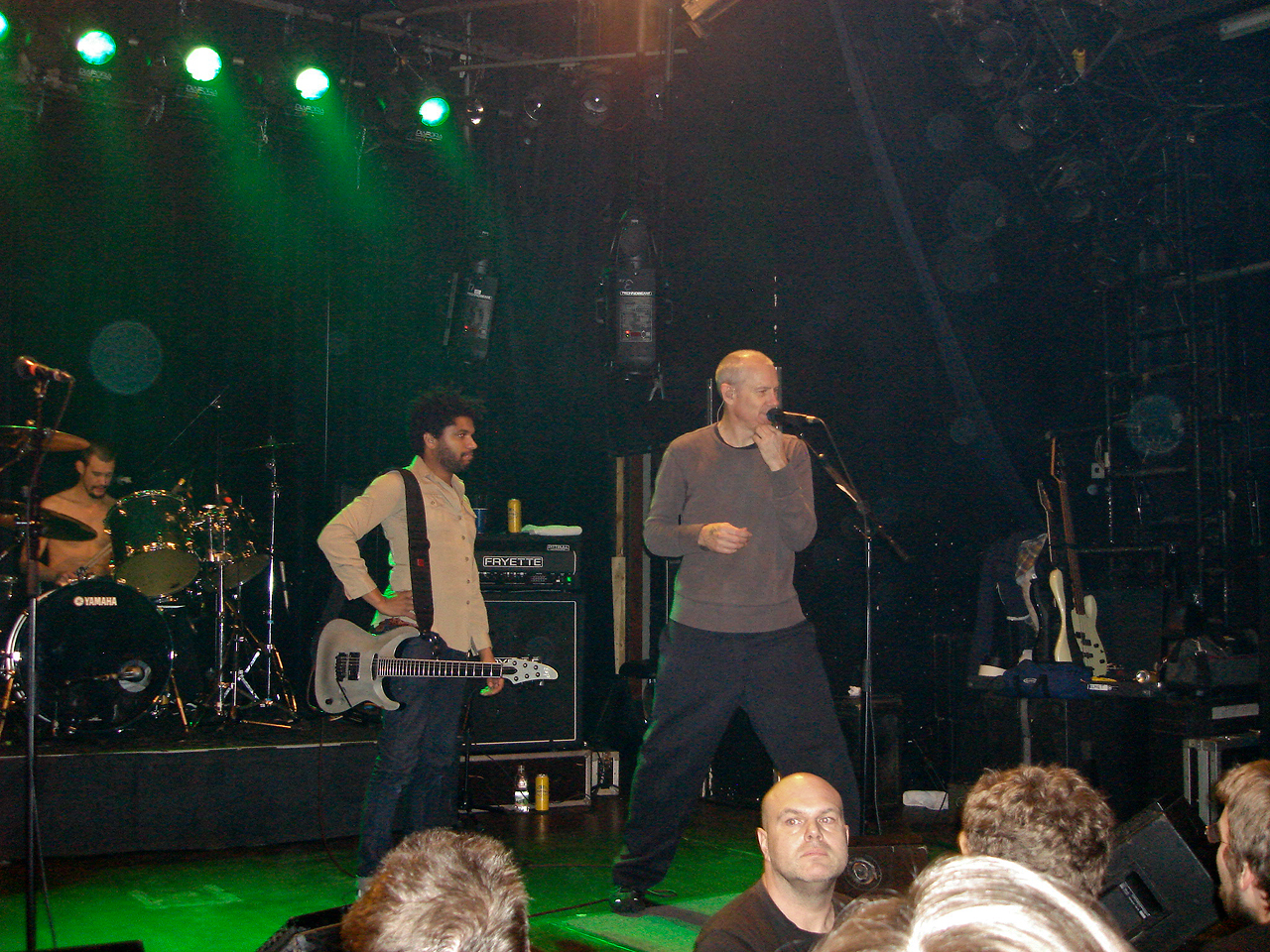 a couple of guys in black pants on stage with microphone