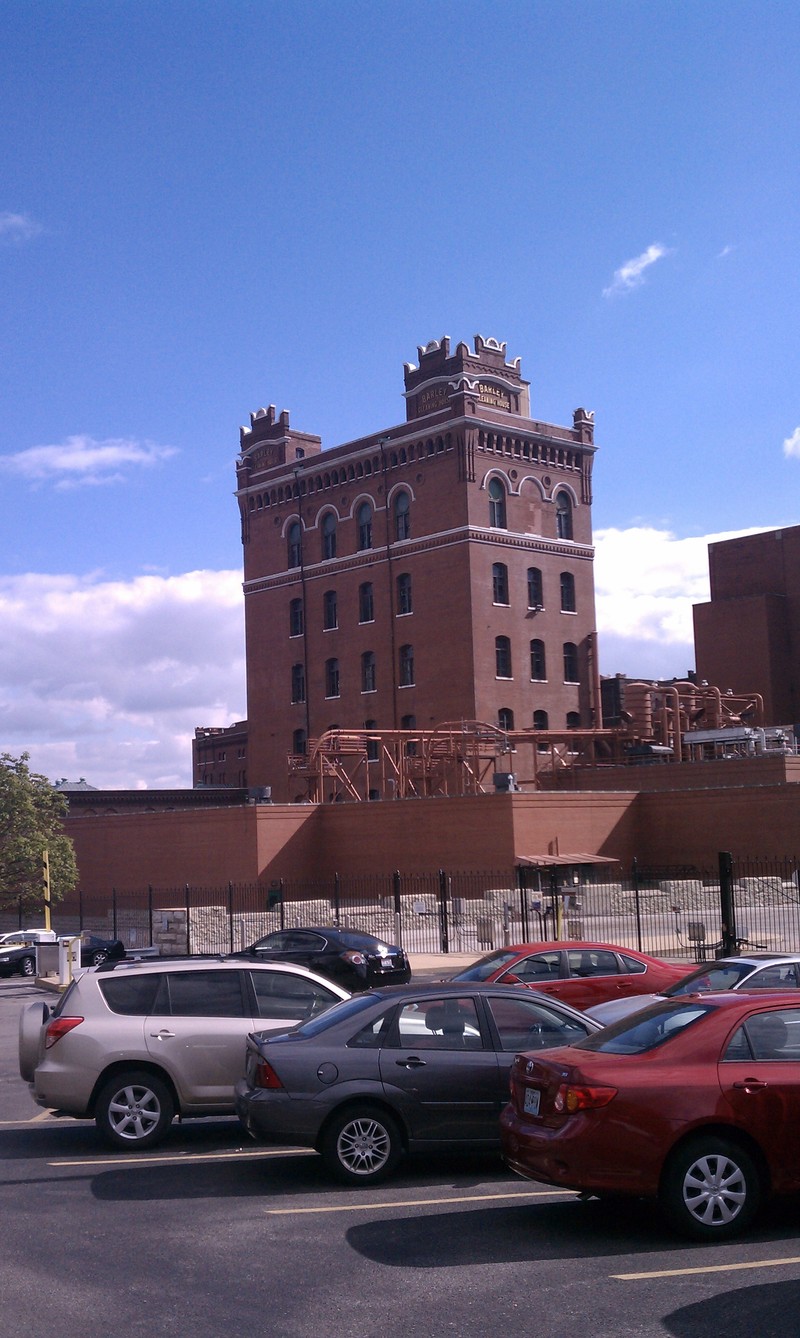 there are cars parked in front of the large building