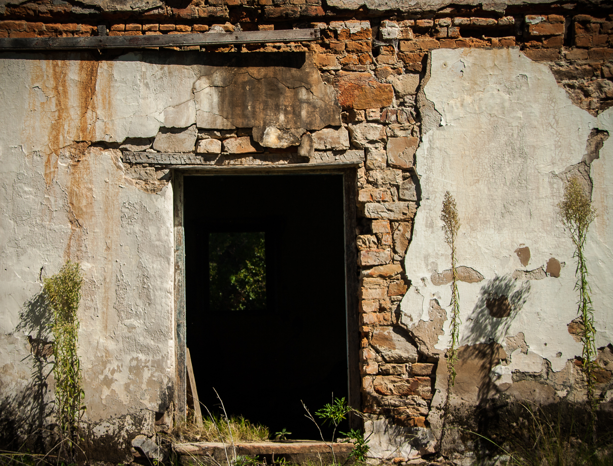 an image of door to an old building that appears to be in ruins