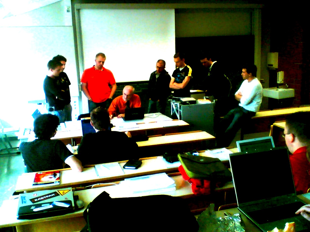 group of students sitting in classroom area with desks