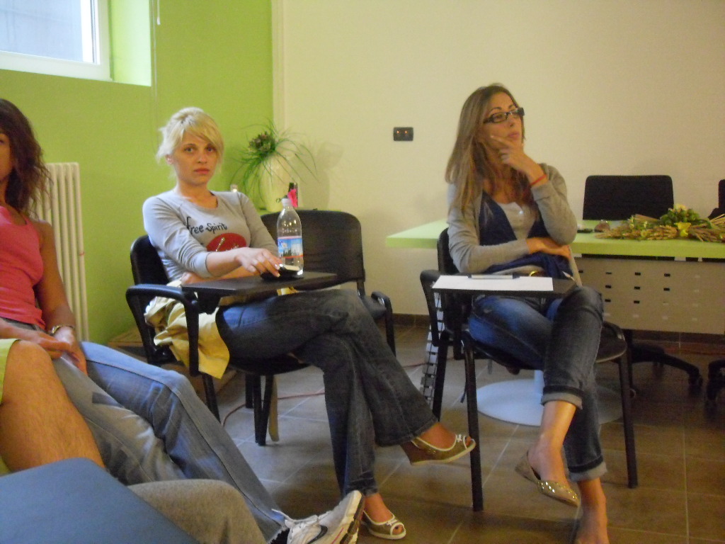 a group of people sitting down on chairs