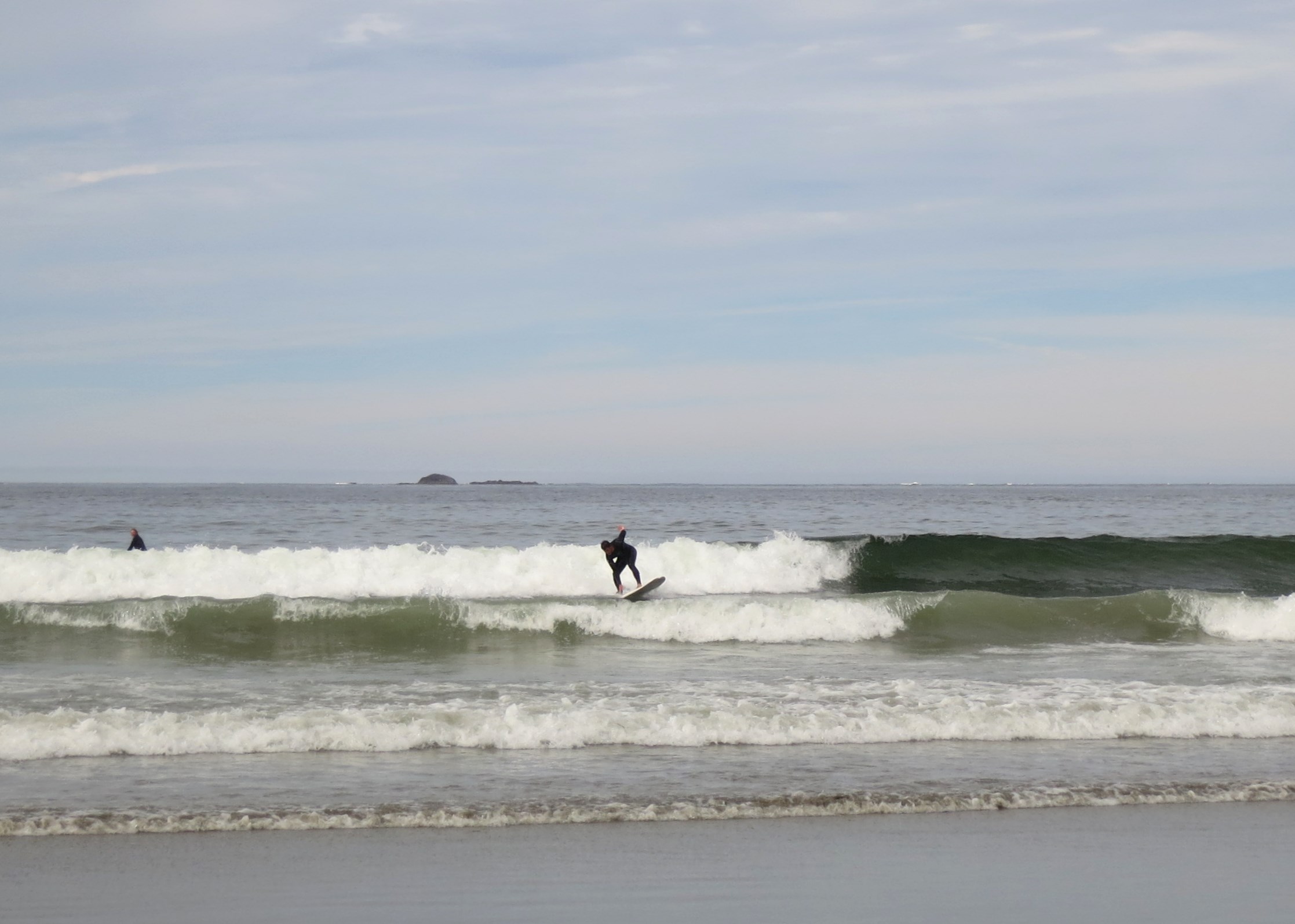 people on surfboards riding on the waves in the ocean