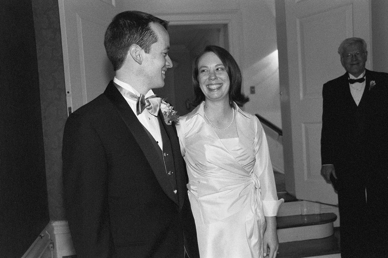 a black and white po of a bride and groom