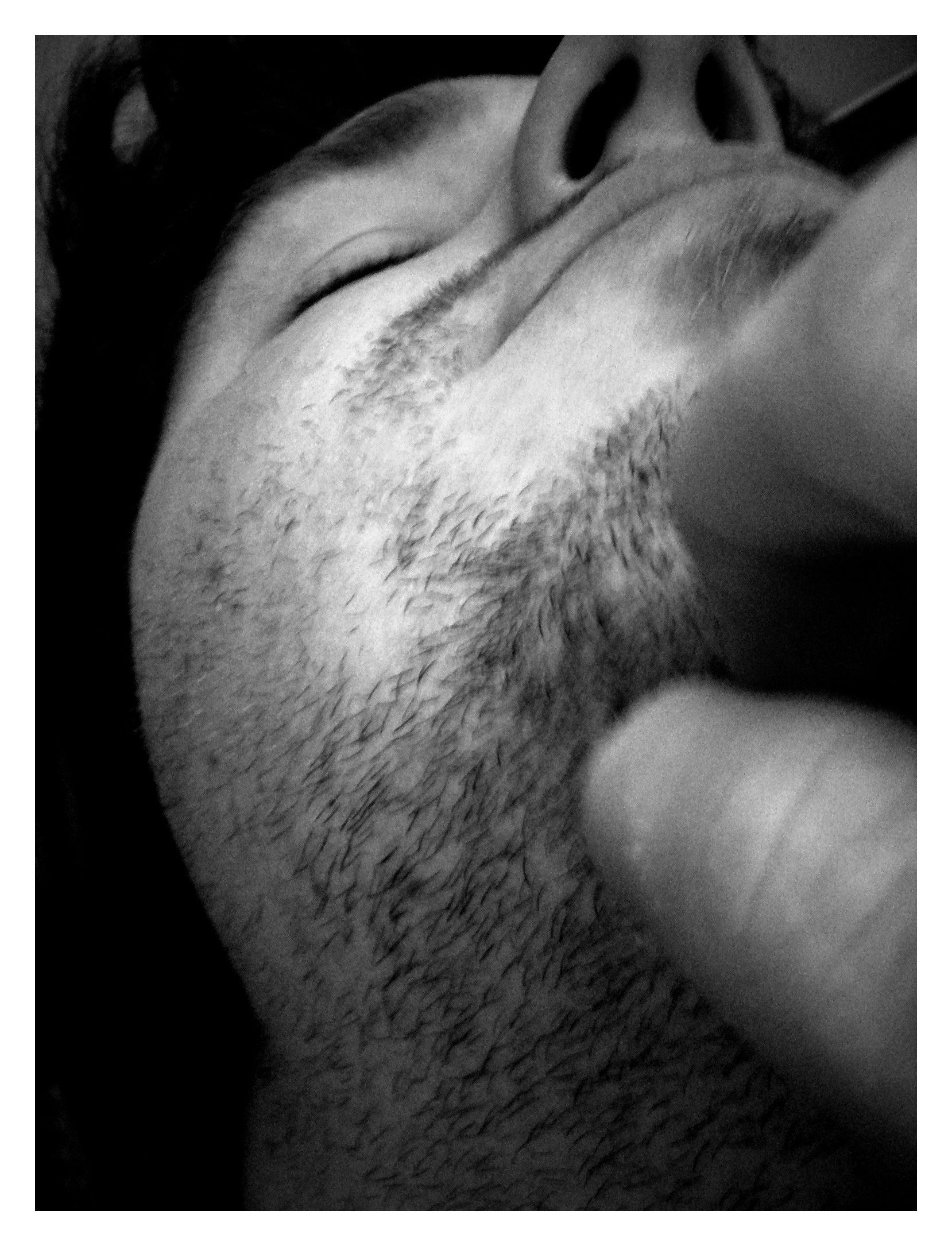 black and white pograph of a man shaving