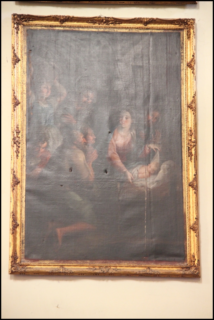 an ornate gold frame hangs in front of a painting of women on a couch