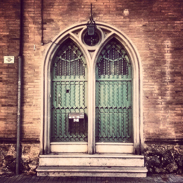 the green doors have a clock on the side of them