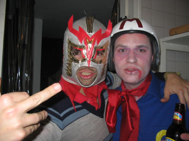 two people in costumes are pointing at the camera