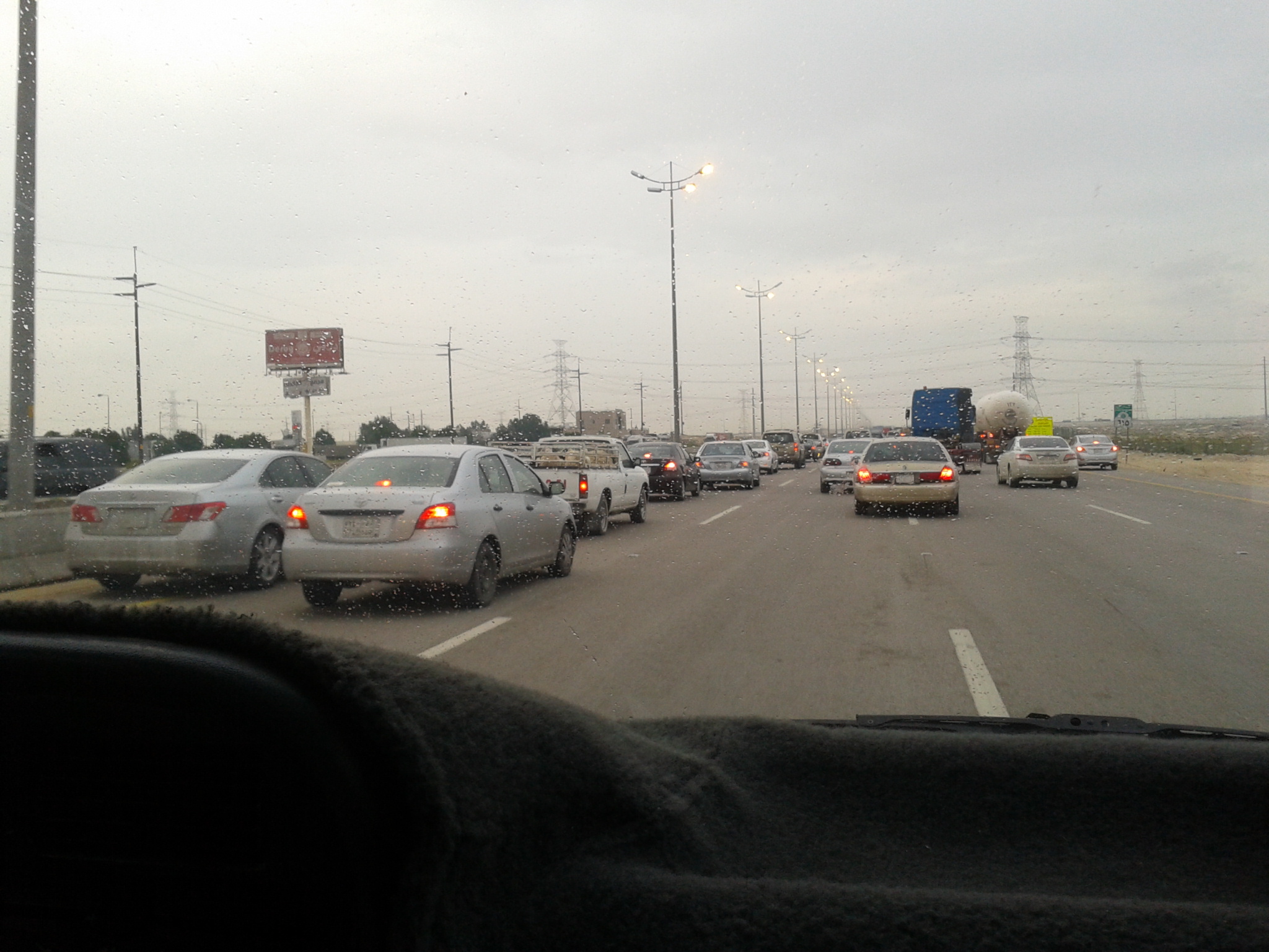 a highway filled with traffic with tall poles