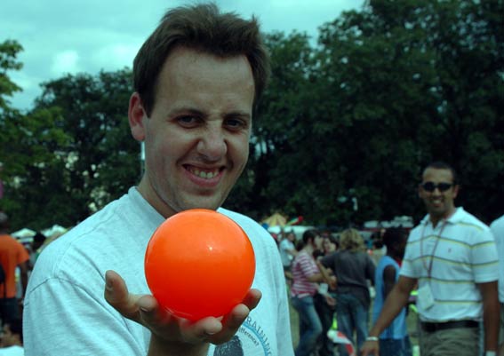 a man is smiling with an orange ball