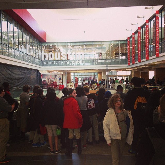 many people stand in a long line to get on the airplane