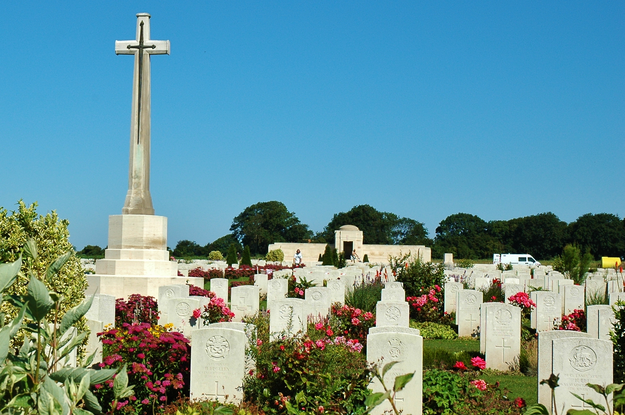 the old cemetery has a cross on it and flowers