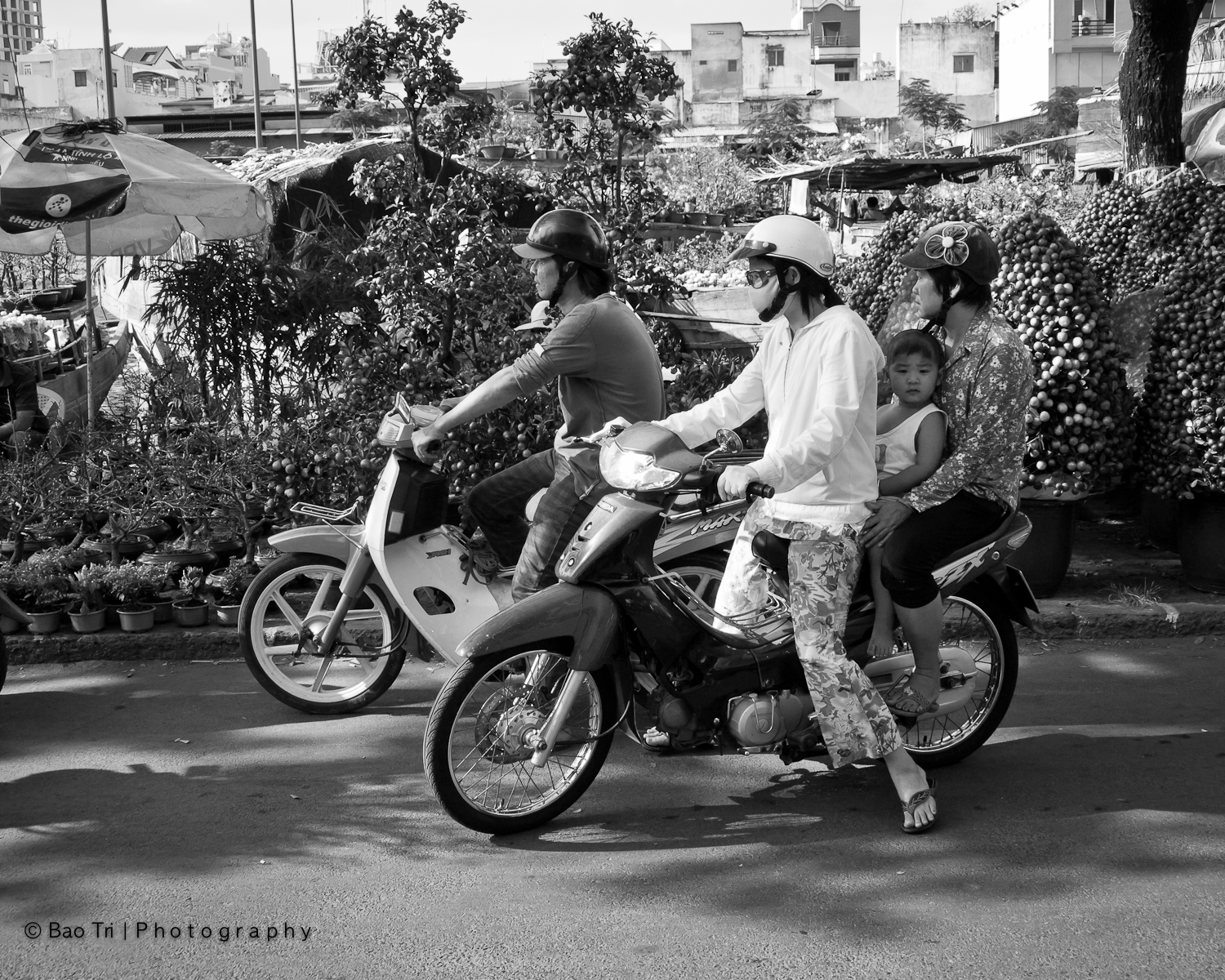 three girls are riding their motorcycles on the road