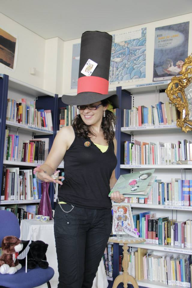 a woman standing in a liry wearing a hat