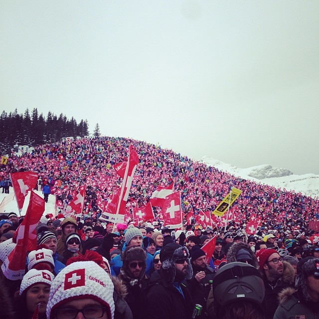a large crowd of people with red flags