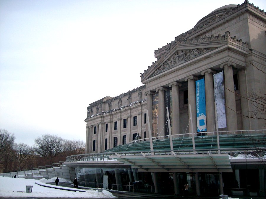 the building is old and has a blue banner on the outside of it