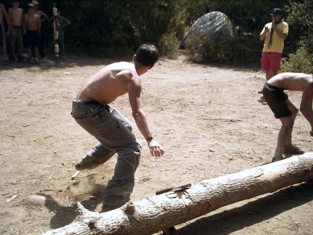 a boy plays a game with a large piece of wood