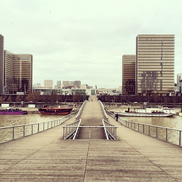 this is a pier on the water next to buildings