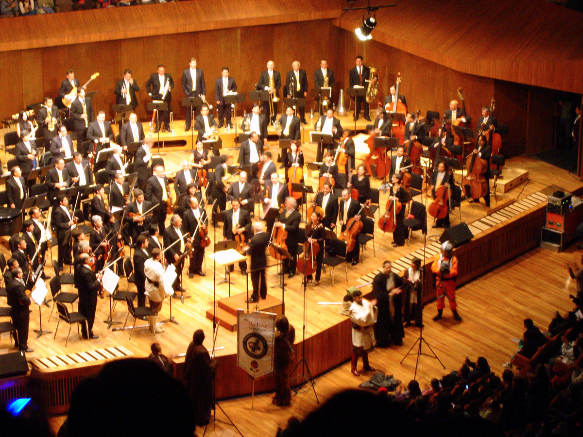 a band and orchestra on stage playing music