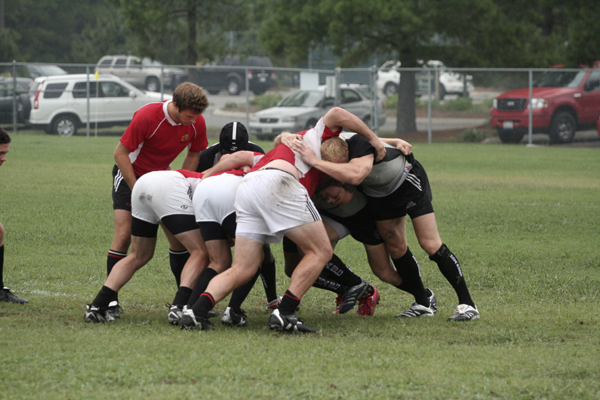 a group of men huddle together on a field