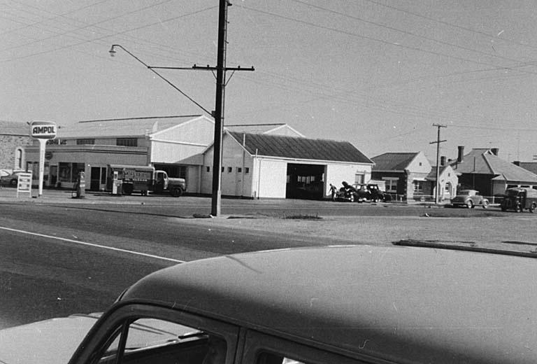 an old pograph of a gas station from the sixties