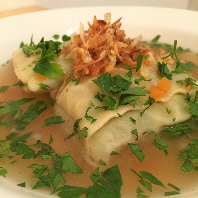 soup in a white bowl with garnishes, garnishes, and parsley