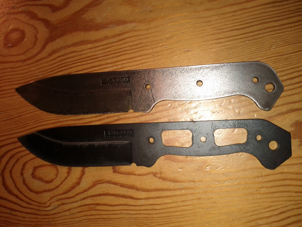 two different knives on a wooden surface