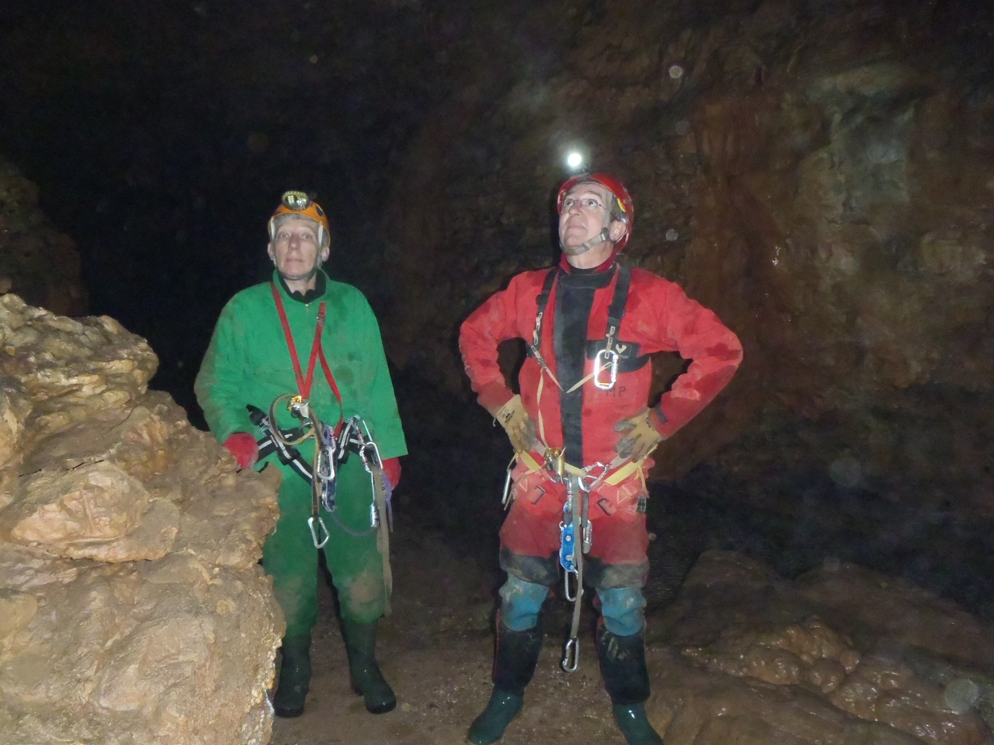 two men are wearing full body chains in a cave