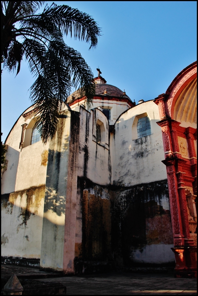 an abandoned building with a clock tower and arched doorway