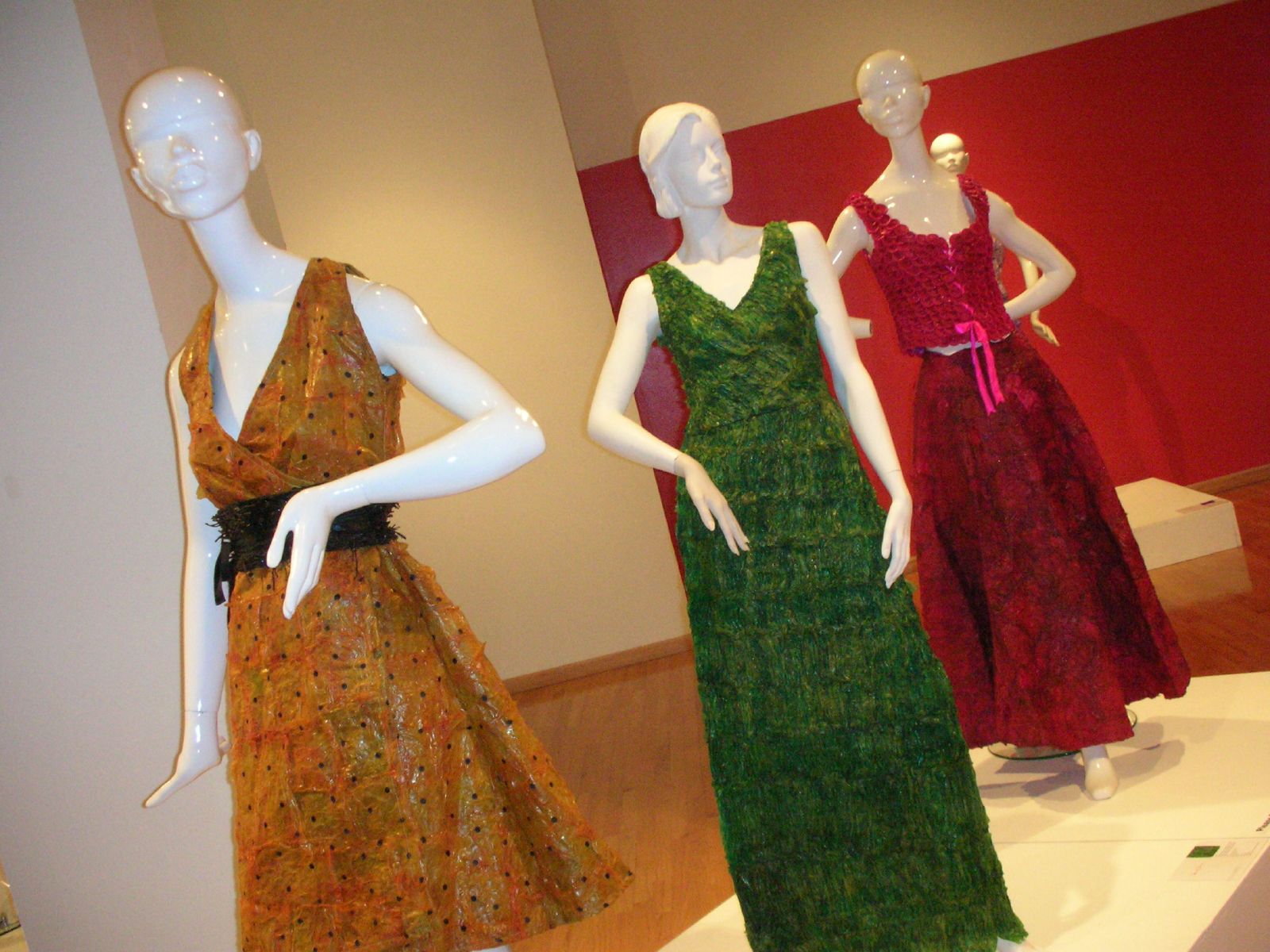 the three dresses are wearing black, yellow, and green