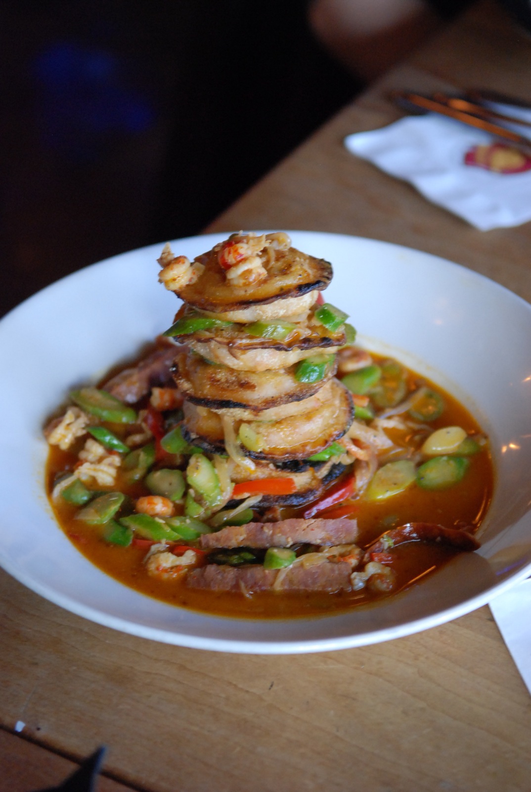 a bowl filled with asian food, and stacked up